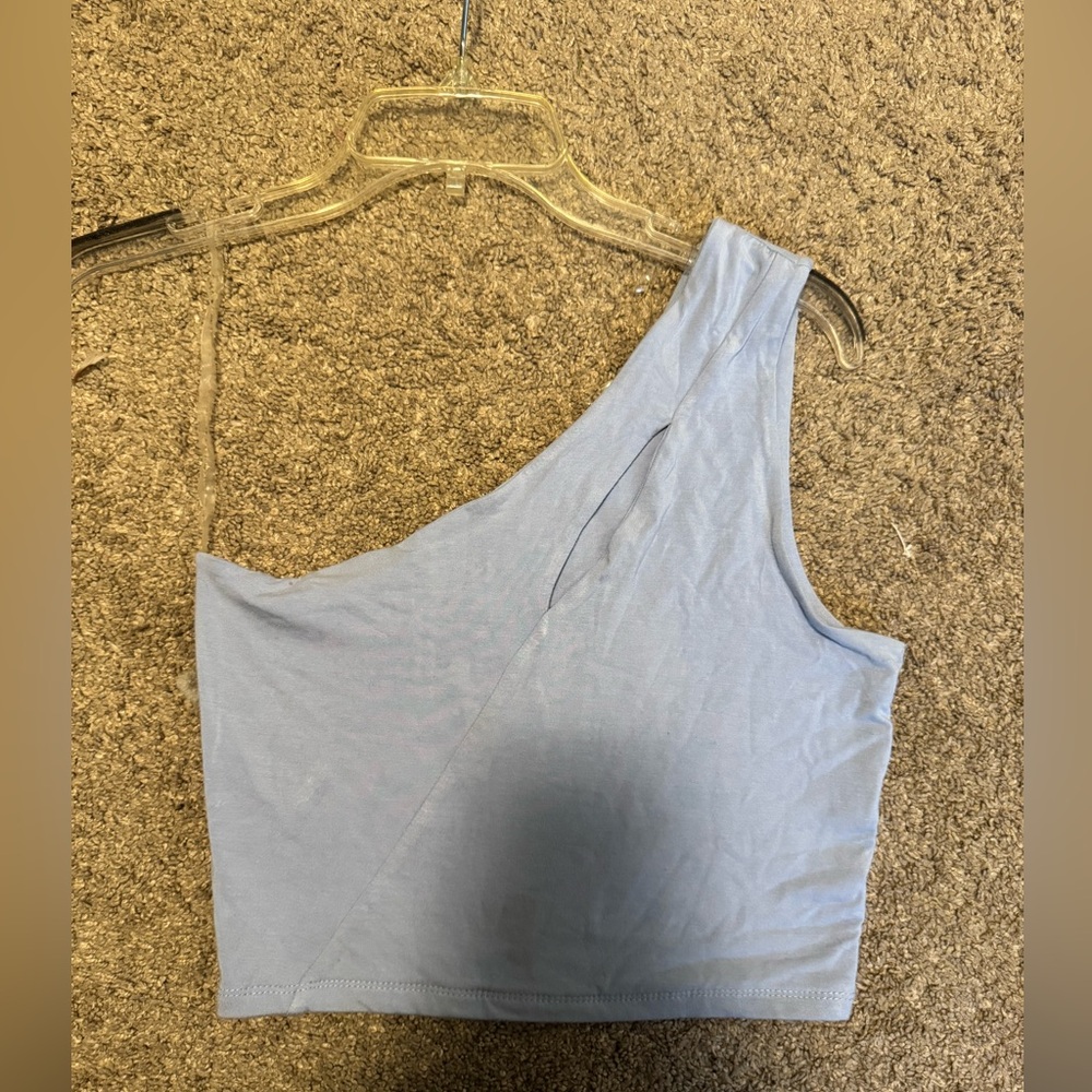 light blue top with cut out on chest. size medium. lightly worn. one shoulder.